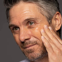 Older gentleman touching face after using Face 4ward clarifying toner