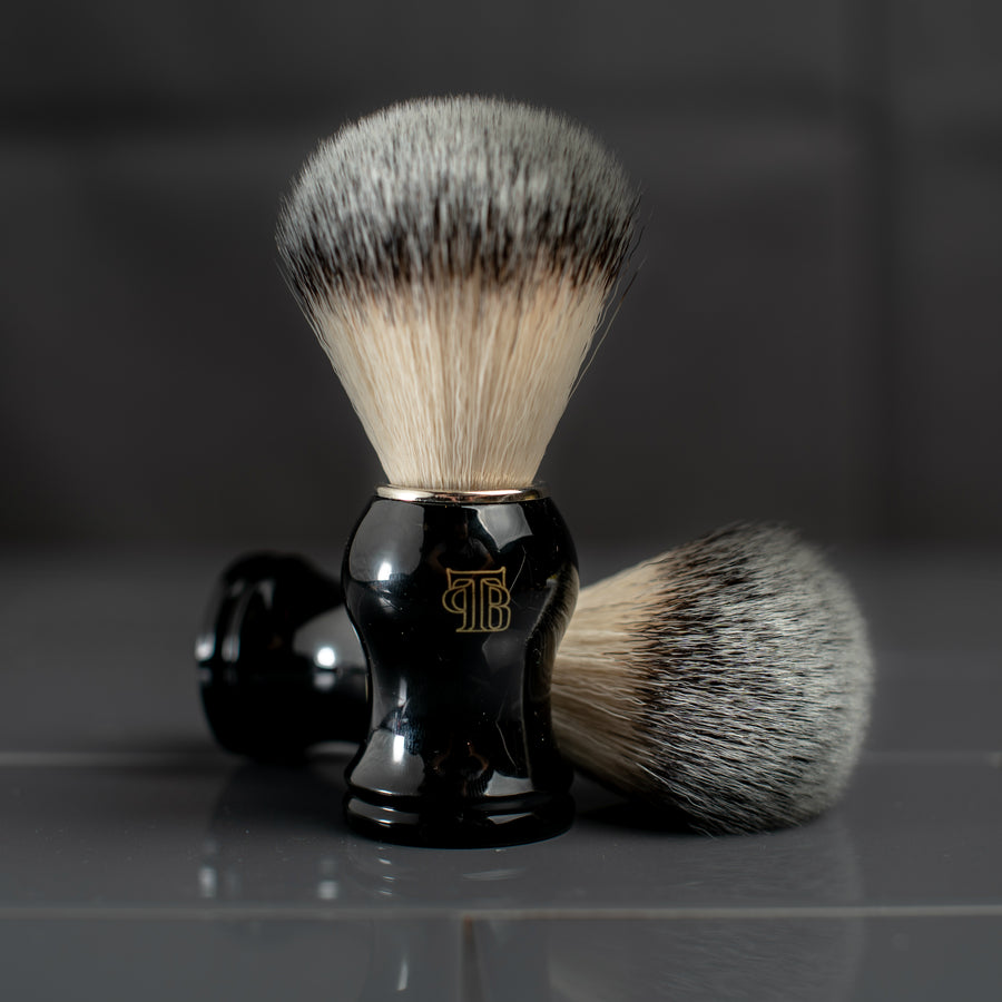 The Personal Barber Synthetic Hair Shaving Brush with black handle, gold logo and chrome collar